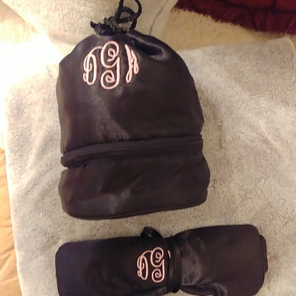 This is a monogrammed pink and black jewelry roll